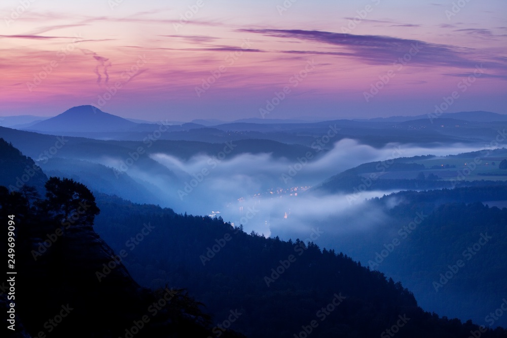 Foggy autumn or summer landscape. Misty foggy morning with sunrise in a valley of Bohemian Switzerland park. Detail of forest, landscape of Czech Republic, beautiful national park Bohemian Switzerland