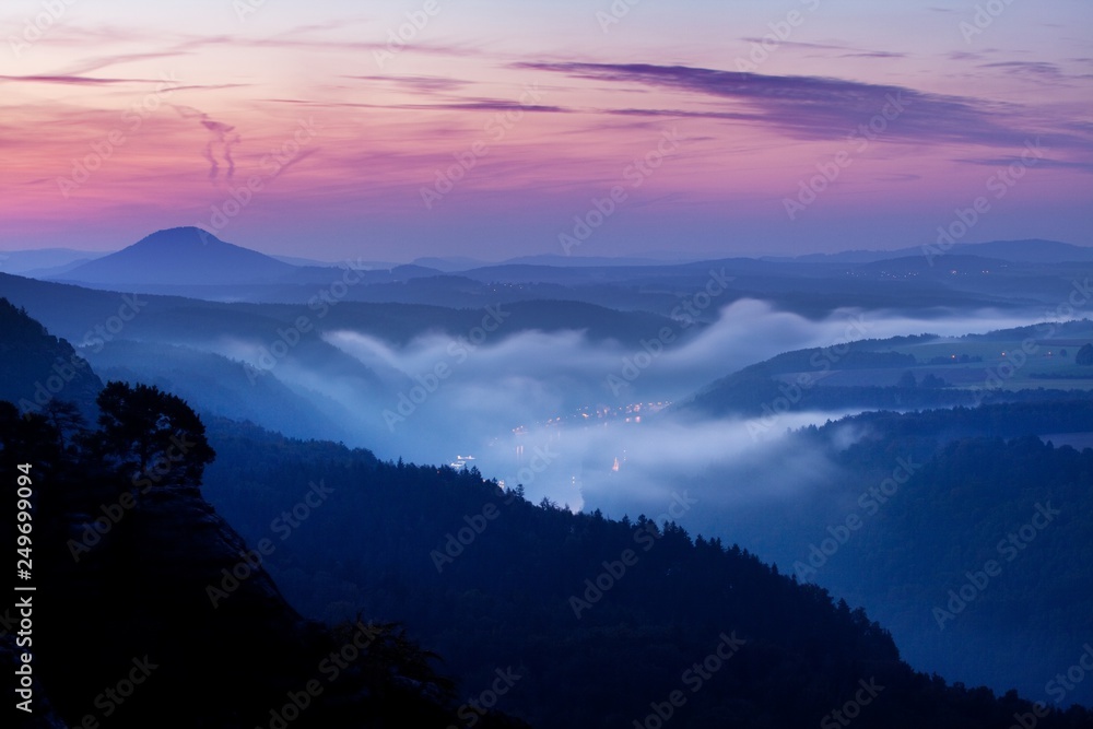 Foggy autumn or summer landscape. Misty foggy morning with sunrise in a valley of Bohemian Switzerland park. Detail of forest, landscape of Czech Republic, beautiful national park Bohemian Switzerland Foggy autumn or summer landscape. Misty foggy morning with sunrise in a valley of Bohemian Switzerland park. Detail of forest, landscape of Czech Republic, beautiful national park Bohemian Switzerland
