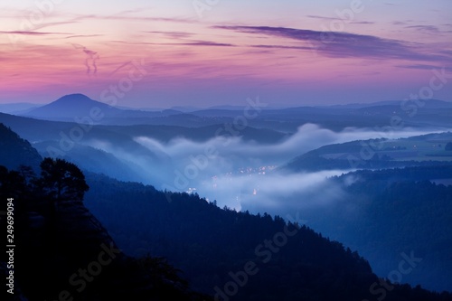 Foggy autumn or summer landscape. Misty foggy morning with sunrise in a valley of Bohemian Switzerland park. Detail of forest, landscape of Czech Republic, beautiful national park Bohemian Switzerland