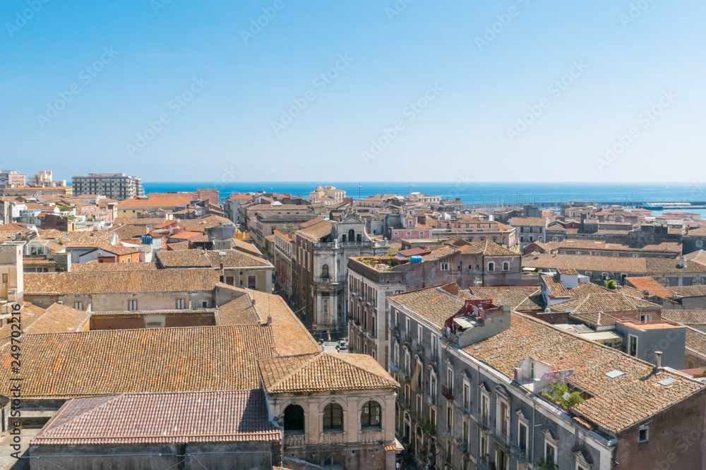 Aerial skyline panoramic view of city of Catania in September,  old town featuring brown, ochre and yellow roofs. Sicily, Italy. Vintage or travel background.
