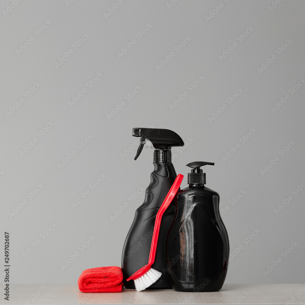 Red and black set of tools and tools for cleaning the kitchen. Neutral background.Copy space. Red and black set of tools and tools for cleaning the kitchen. Neutral background.Copy space.