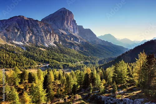Gorgeous sunny view of Dolomite Alps with yellow larch trees. Colorful autumn scene of Tofana di rozes mountain range. Falzarego pass location, Italy, Europe. Beauty of nature concept background © Michal
