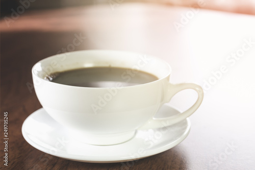 A cup of hot coffee on a wooden table