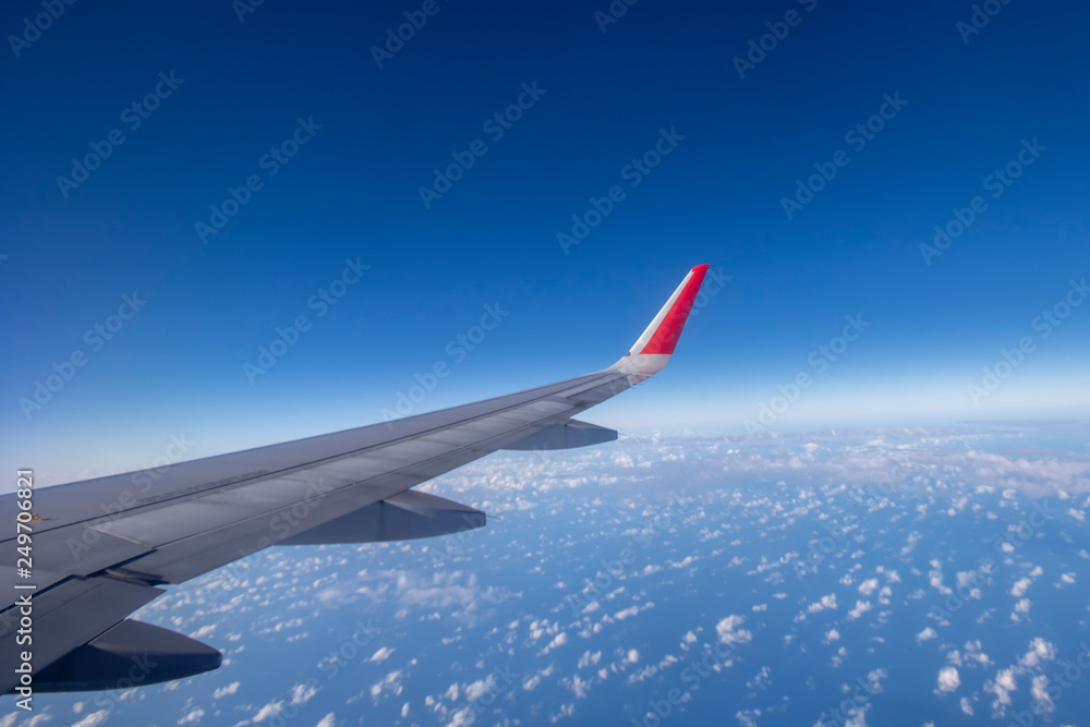 Fototapeta premium Aeroplane wing view from window beautiful sky. Traveling concept