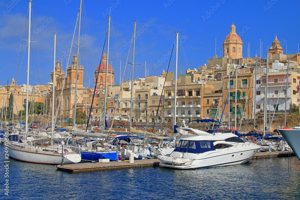 Coast of the city of Birgu in Malta with moored yachts.