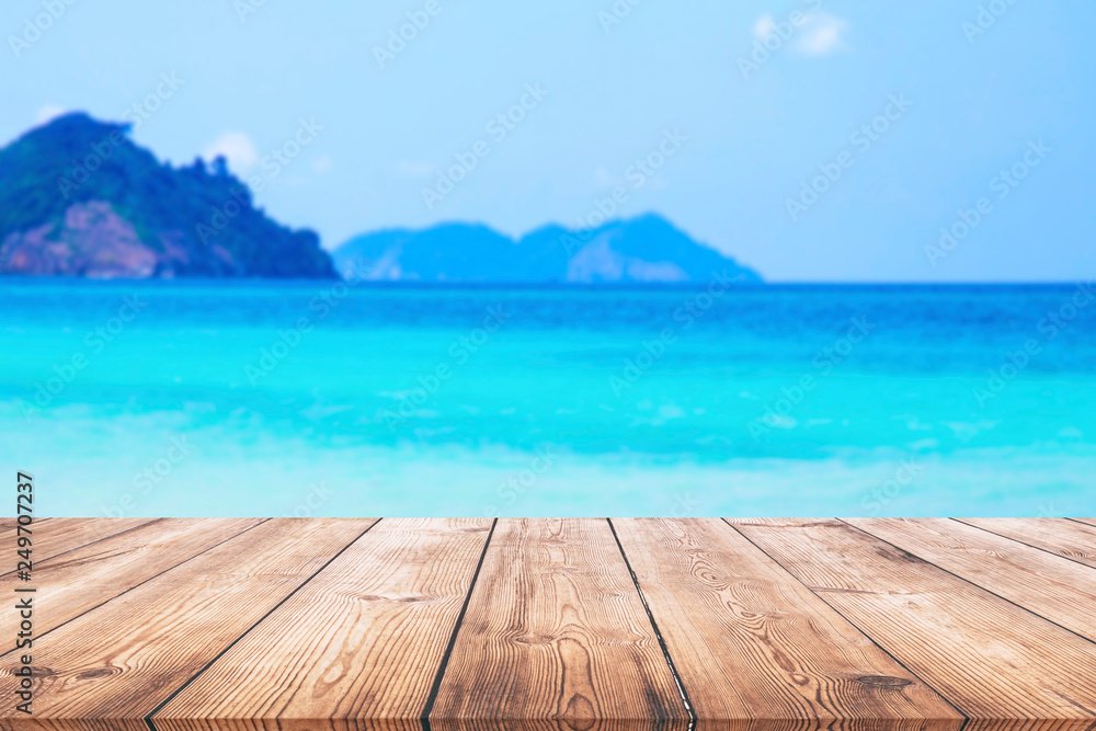 Wood table and beautiful sea with sand beach background