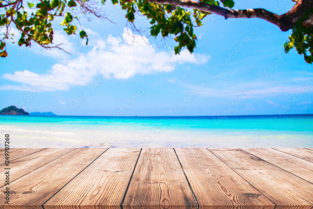 Wood table and beautiful sea with sand beach background Wood table and beautiful sea with sand beach background