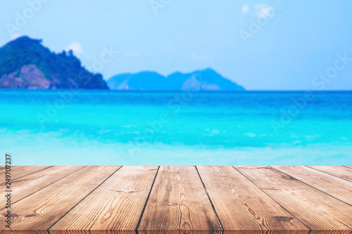 Wood table and beautiful sea with sand beach background © Thanakorn Thaneevej