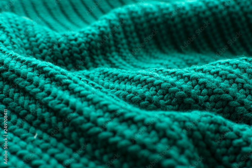 Knitted green background close up.
