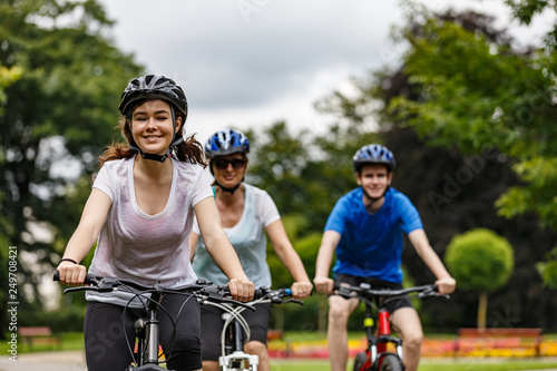 Healthy lifestyle - people riding bicycles in city park