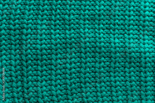 Knitted green background close up.