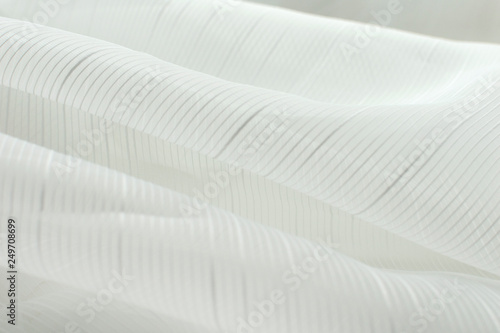 white cloth closeup. Smooth soft curves of the fabric. Can be used as background.