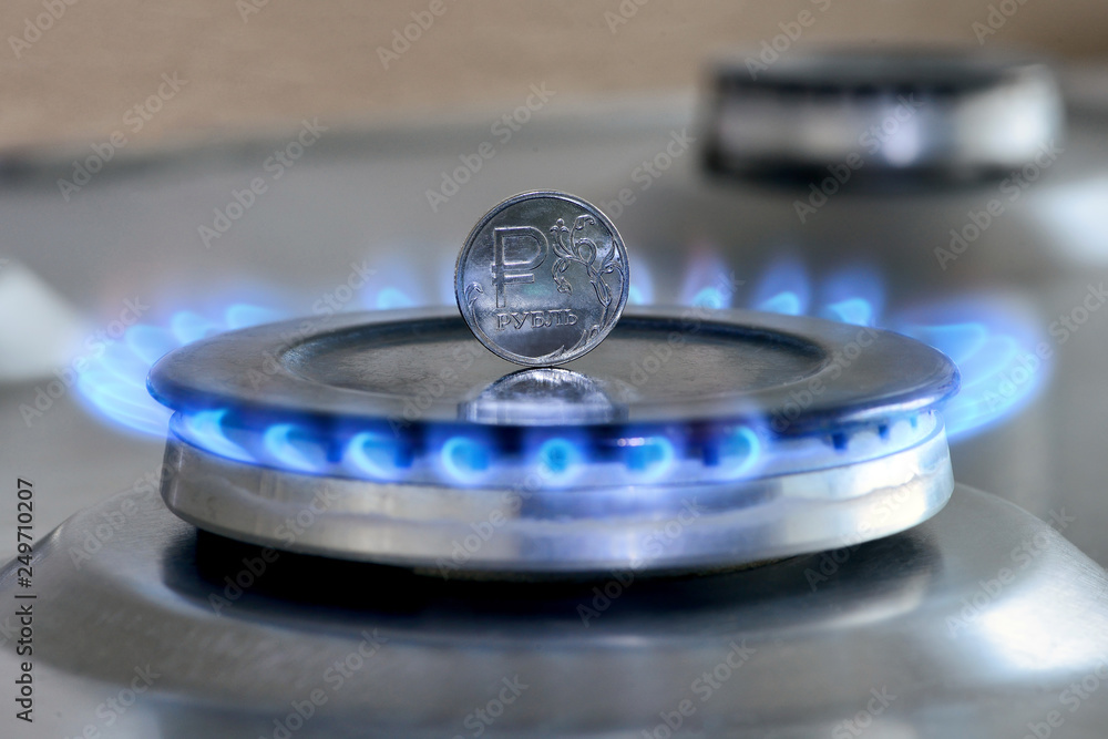 Gas hob with burning natural gas and Russian rouble coin Gas hob with burning natural gas and Russian rouble coin