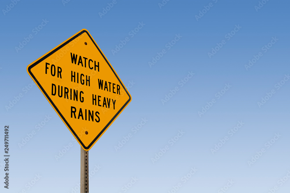Watch For High Water Sign With Clear Blue Sky
