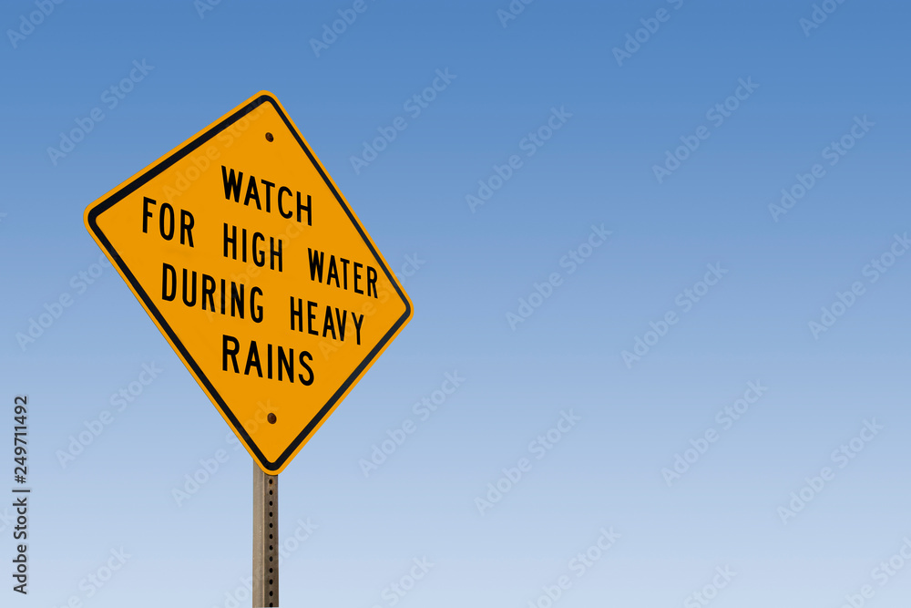 Watch For High Water Sign With Clear Blue Sky Watch For High Water Sign With Clear Blue Sky