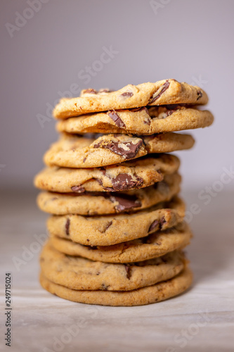 Stacked chocolate chip chunk cookies on light background