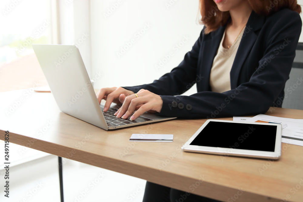Selective focus on hands of business woman working with laptop on the workplace in office. Selective focus on hands of business woman working with laptop on the workplace in office.