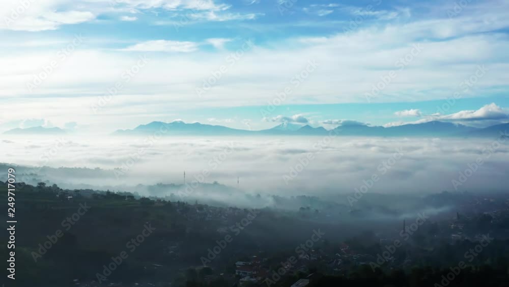 Beautiful aerial view of misty morning in Bandung city with fog covered the city, West Java, Indonesia. Shot in 4k resolution Beautiful aerial view of misty morning in Bandung city with fog covered the city, West Java, Indonesia. Shot in 4k resolution