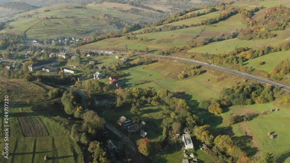 Aerial View Of The Landscape With Small Village In Mountains, Highway Through the Village in the Carpathian Mountains, Fog in the Valley Aerial View Of The Landscape With Small Village In Mountains, Highway Through the Village in the Carpathian Mountains, Fog in the Valley