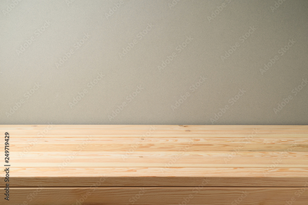 Empty wooden table over grey wall background. Empty wooden table over grey wall background.