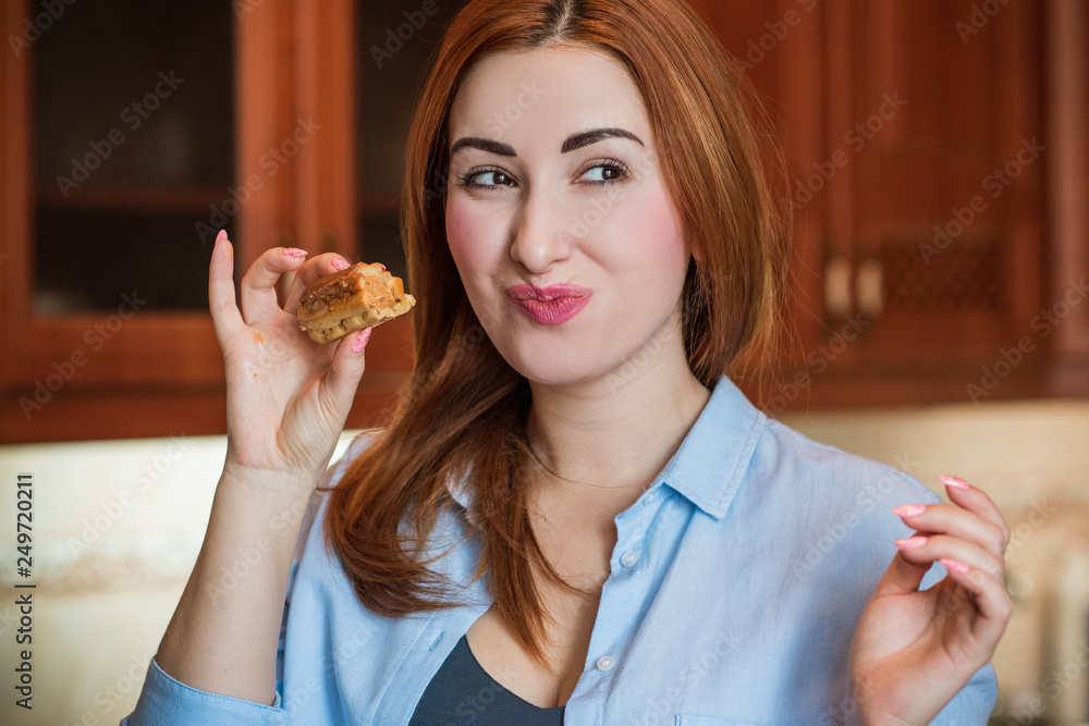 Plus size young nice woman eating cake. Woman desire, sugar concept Plus size young nice woman eating cake. Woman desire, sugar concept