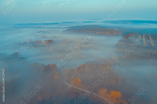 Early foggy morning. Aerial view of countryside and country road © vvvita