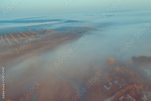 Early foggy morning. Aerial view of countryside and country road