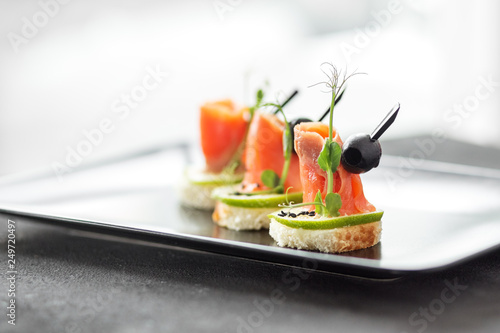 Delicious appetizers with red fish and lime. Concept of food, restaurant, catering, menu.