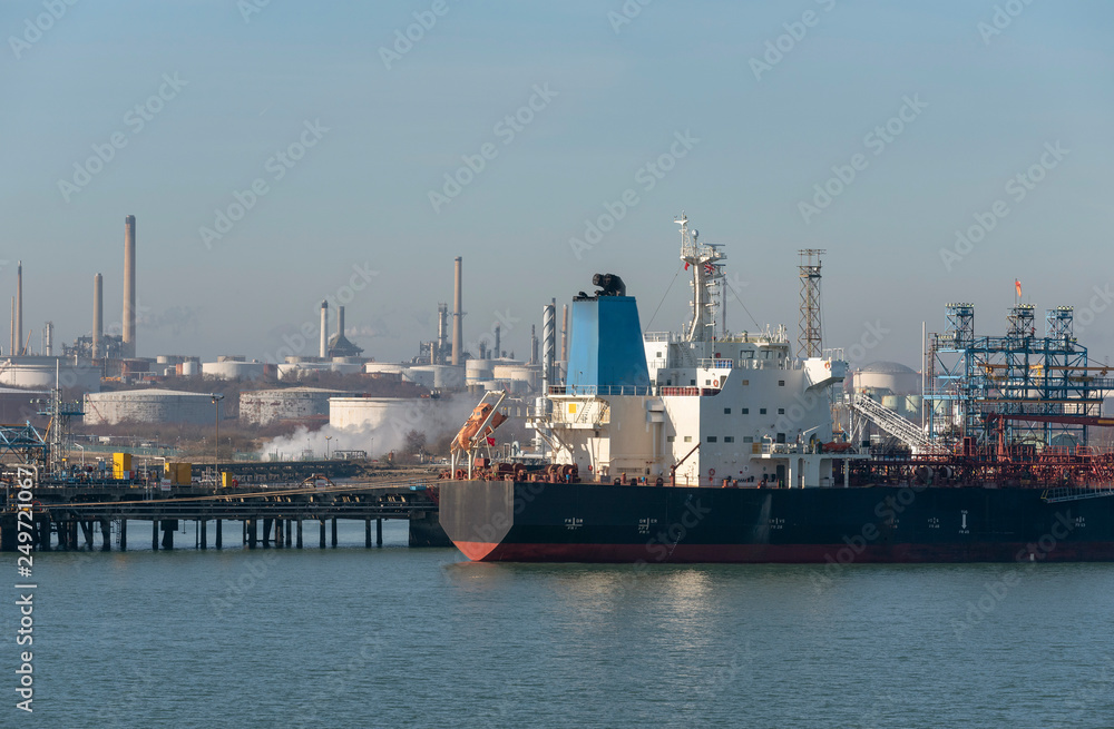An oil products tanker vessel unloading on a refinery berth