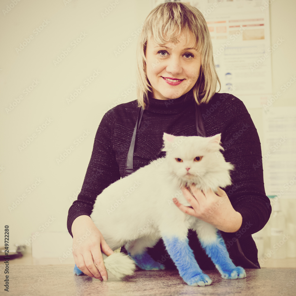 Happy owner with her cat after treatment in vet clinic Happy owner with her cat after treatment in vet clinic