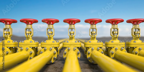 Yellow gas pipe line valves. Oil and gas extraction, production and transportation industrial background.
