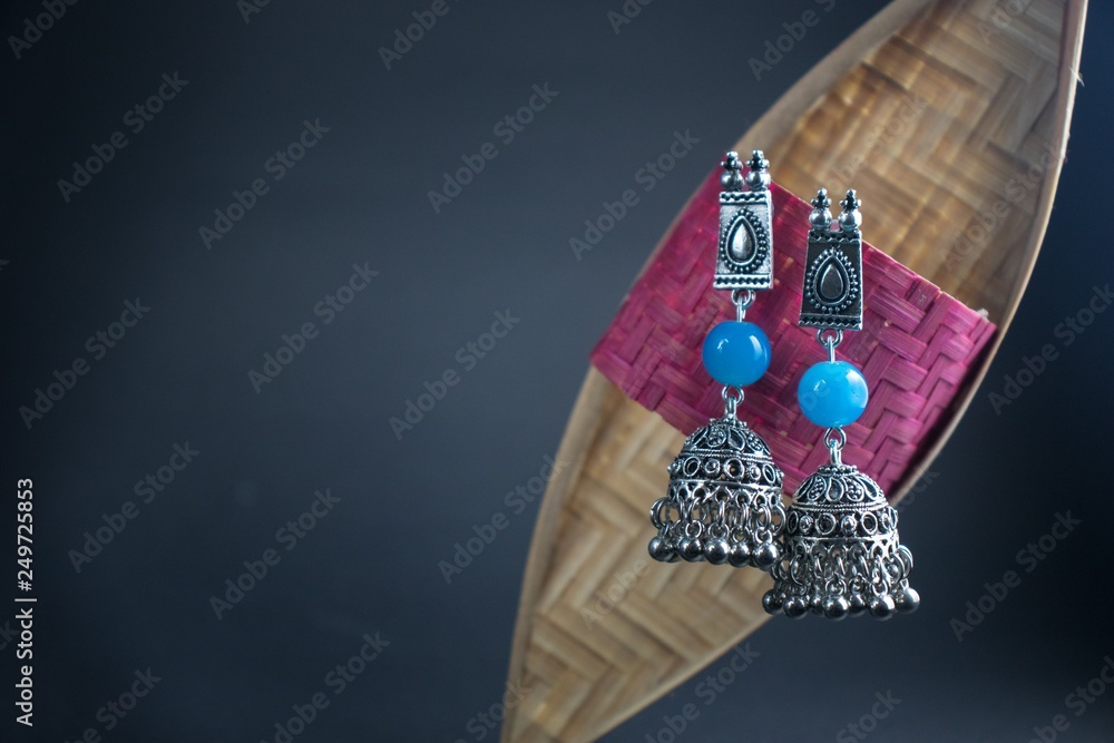 Blue Jhumka Earrings against light grey background
