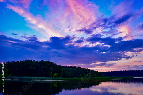 Purple and orange sunset over a lake with reflections in the lake