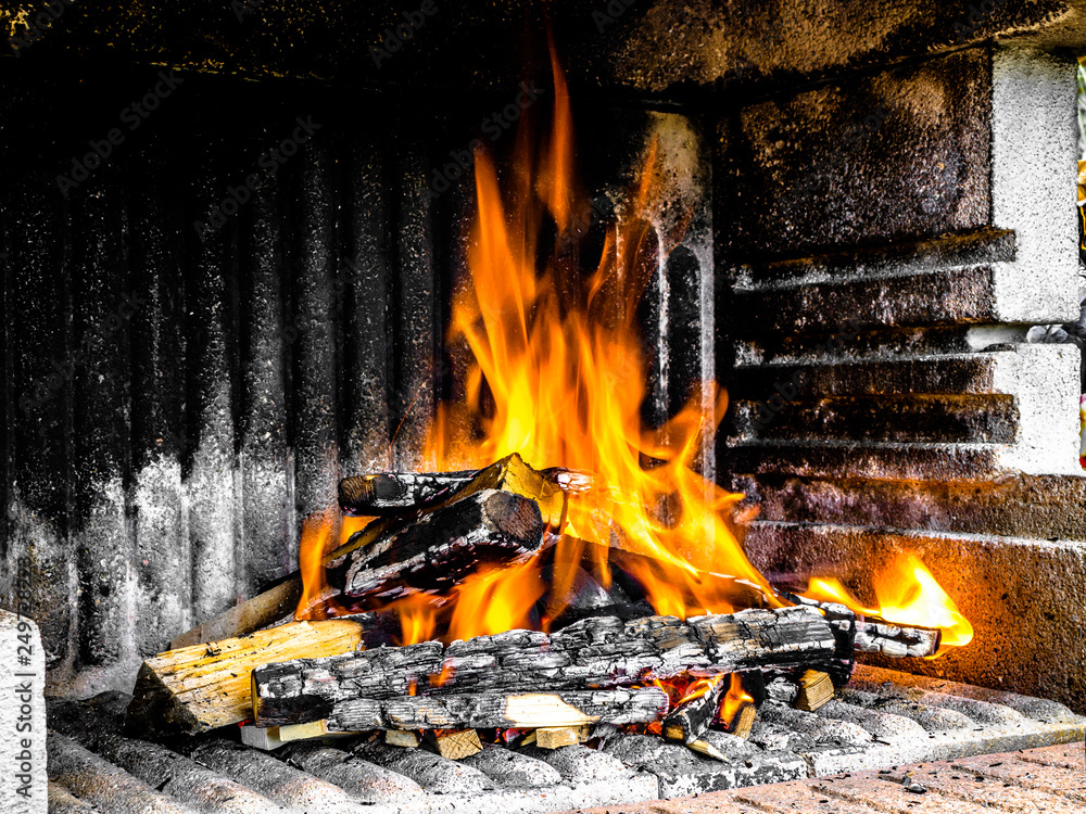 Preparation of a BBQ - wood piled up - fire reaching maximum heat Preparation of a BBQ - wood piled up - fire reaching maximum heat