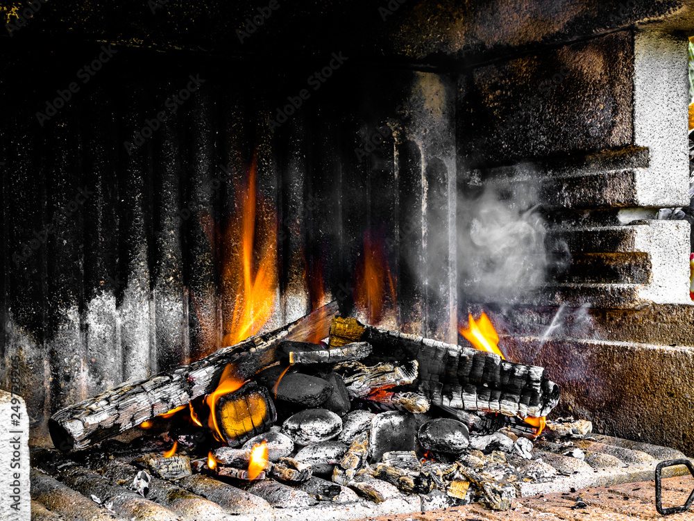 Preparation of a BBQ - wood piled up - fire reaching maximum heat
