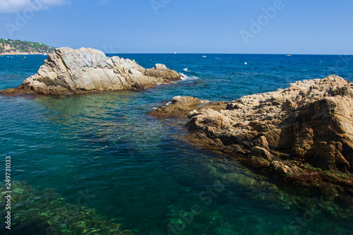 Rocks in seaside Lloret de Mar, Costa Brava, Spain. Nature sea landscape on sunny day.