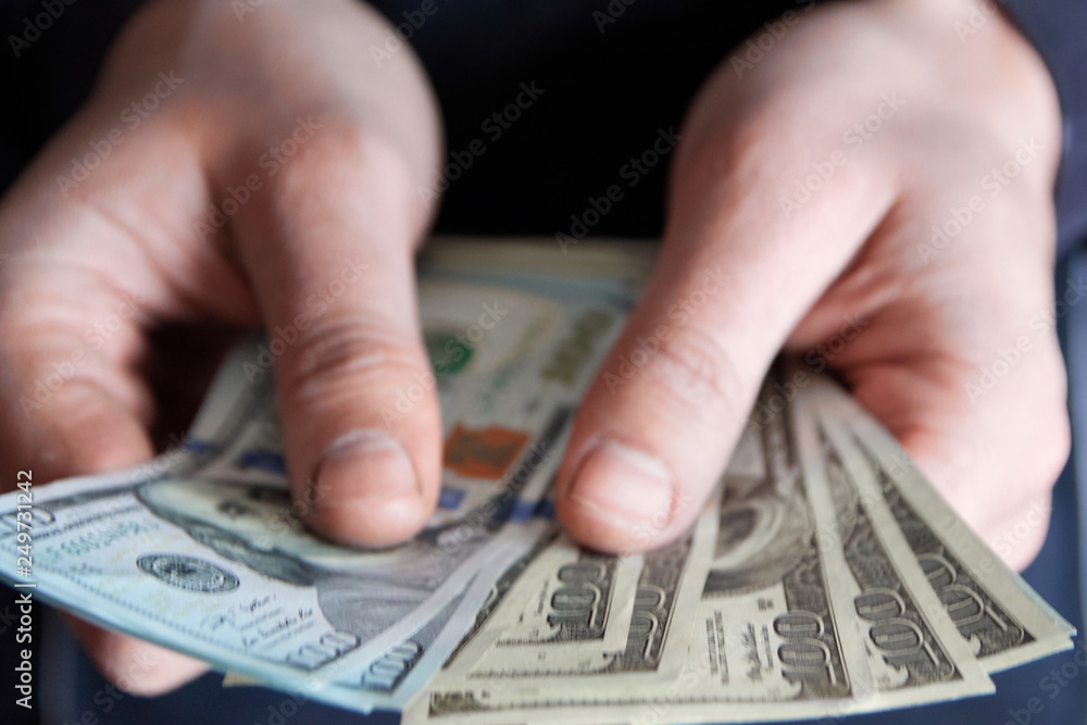 Man holdin money. Concept of savings, salary, payment and funds. Man counts cash bills.. Man holdin money. Concept of savings, salary, payment and funds. Man counts cash bills..