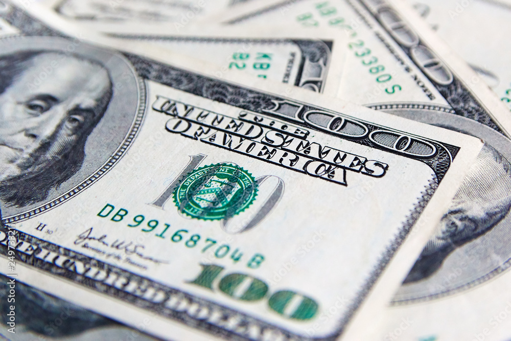 A pile of one hundred US banknotes with president portraits. Cash of hundred dollar bills, dollar background image with high resolution A pile of one hundred US banknotes with president portraits. Cash of hundred dollar bills, dollar background image with high resolution