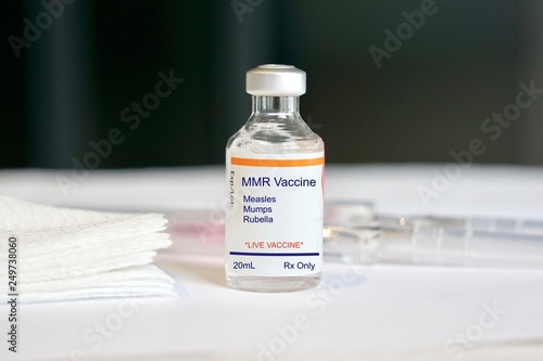 Concept of an MMR vaccine against measles, mumps, and rubella in a vial photo