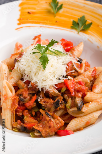 tasty vegetarian penne pasta in white plate