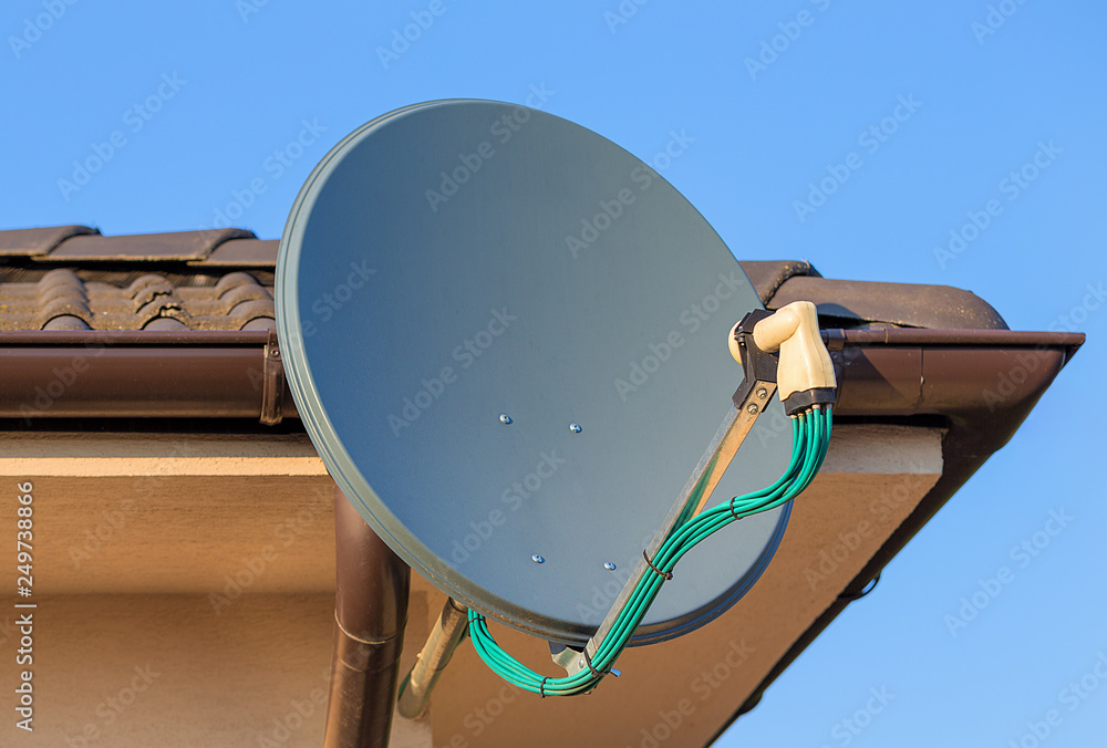 Domestic satellite tv installation under the eaves of home with octo