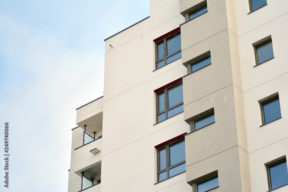 Modern apartment buildings on a sunny day with a blue sky. Facade of a modern apartment building Modern apartment buildings on a sunny day with a blue sky. Facade of a modern apartment building