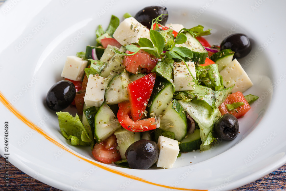 fresh tasty greek salad appetizer on white plate