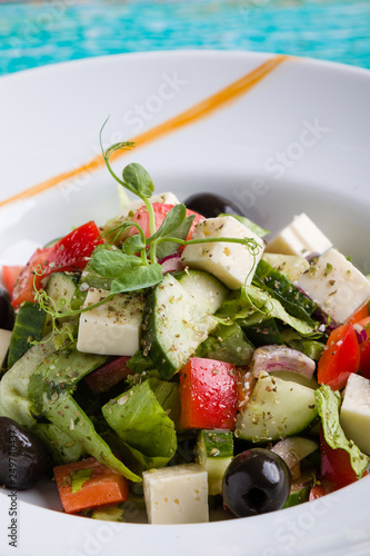 fresh tasty greek salad appetizer on white plate