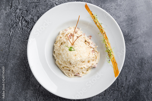 italian spahetti carbonara pasta in white plate photo