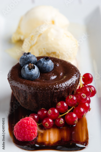 lava cake with ice cream and fruits on white plate