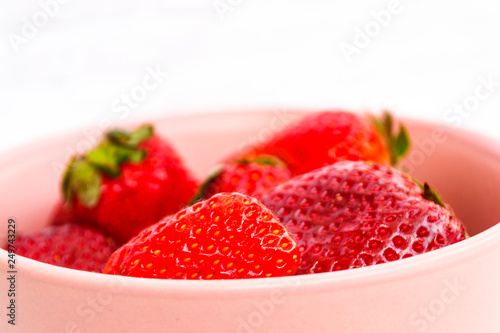 Sweet, juicy, ripe strawberries. Red, large strawberries in a pink cup. Food with vitamins. Vegetarian food. photo