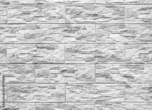 Abstract black and white background. Artificial stone wall. Stone texture, stone uneven surface.