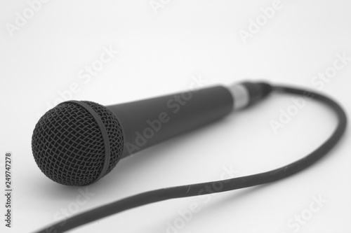Black microphone on bright background