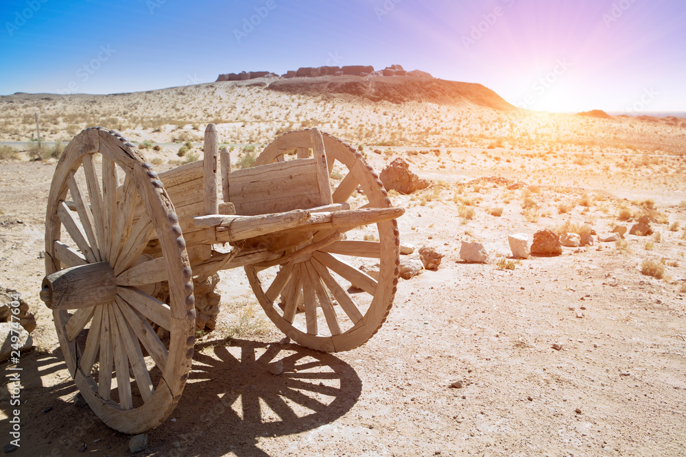 An old wooden cart on two wagon wheels in the Kyzyl Kum desert, Uzbekistan